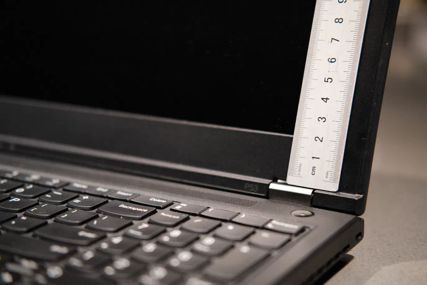 A metric ruler held up to the lower bezel of a ThinkPad P53 A metric ruler held up to the lower bezel of a ThinkPad P53